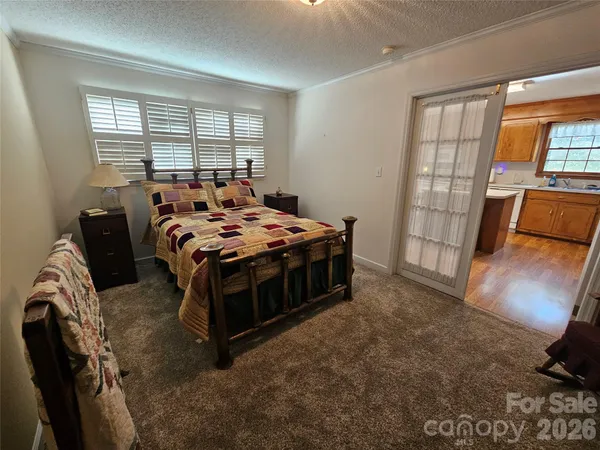 a bed sitting in a bedroom next to a window