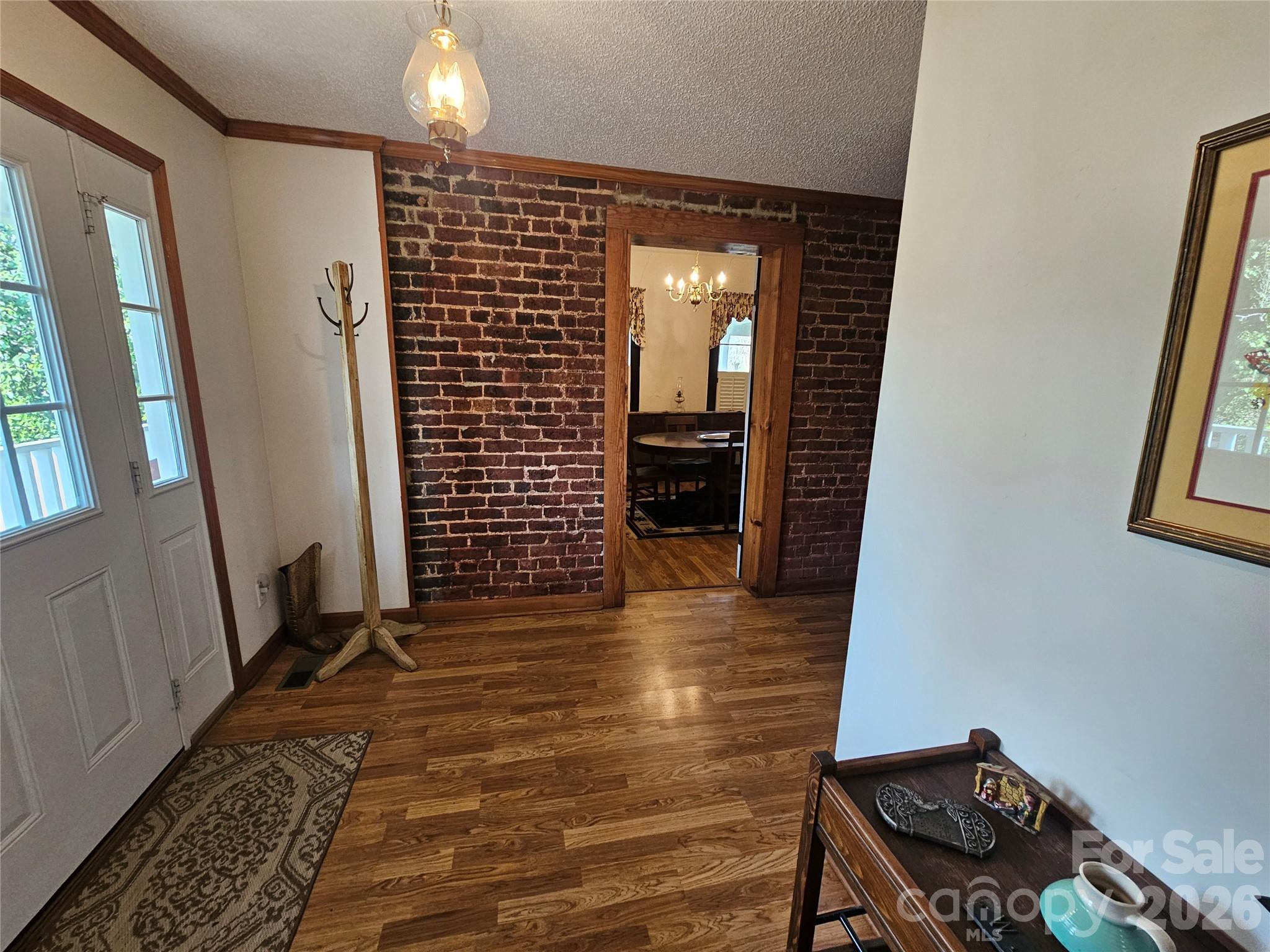 711 Chesterfield Avenue Lancaster, SC 29720 - Photo 15 of 19 a view of a hallway with wooden floor and a bathroom