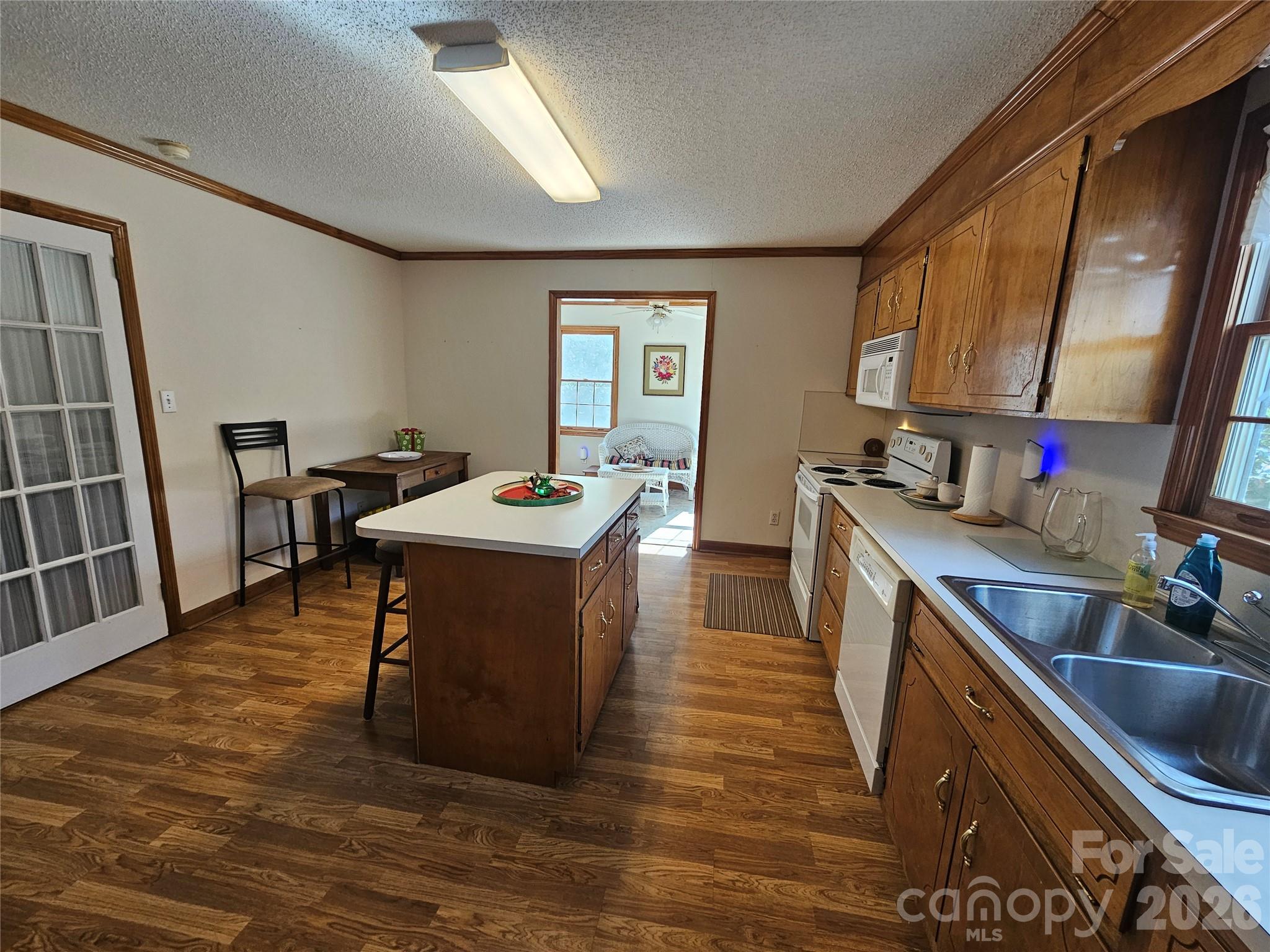 711 Chesterfield Avenue Lancaster, SC 29720 - Photo 16 of 19 a kitchen with a sink stove and cabinets