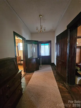 a bedroom with a bed large mirror on dresser and a window