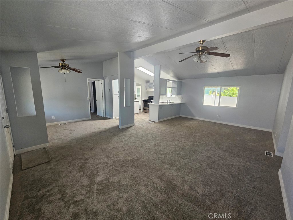 1721 East Colton Avenue, Unit 33 Redlands, CA 92374 - Photo 1 of 17 a view of empty room with windows and ceiling fan
