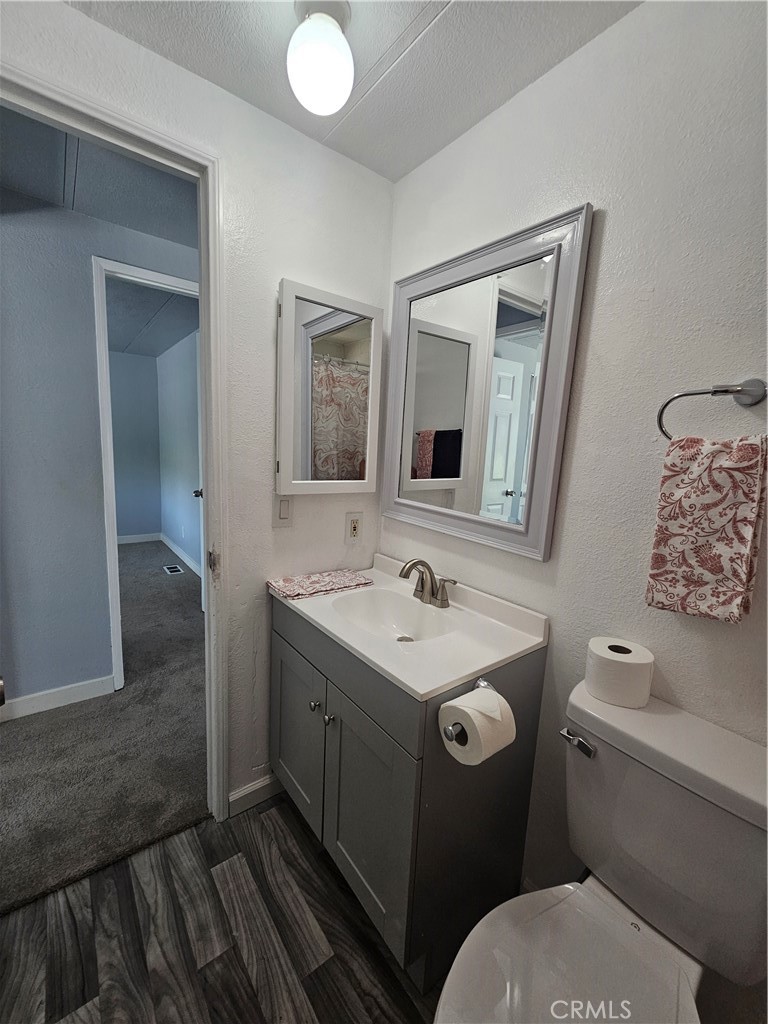 1721 East Colton Avenue, Unit 33 Redlands, CA 92374 - Photo 13 of 17 a bathroom with a toilet sink and mirror