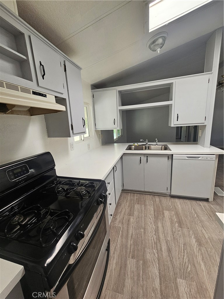 1721 East Colton Avenue, Unit 33 Redlands, CA 92374 - Photo 15 of 17 a kitchen with a stove and a microwave