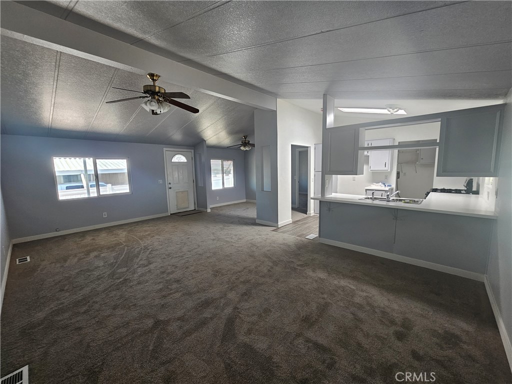 1721 East Colton Avenue, Unit 33 Redlands, CA 92374 - Photo 2 of 17 a living room with a window furniture and a ceiling fan
