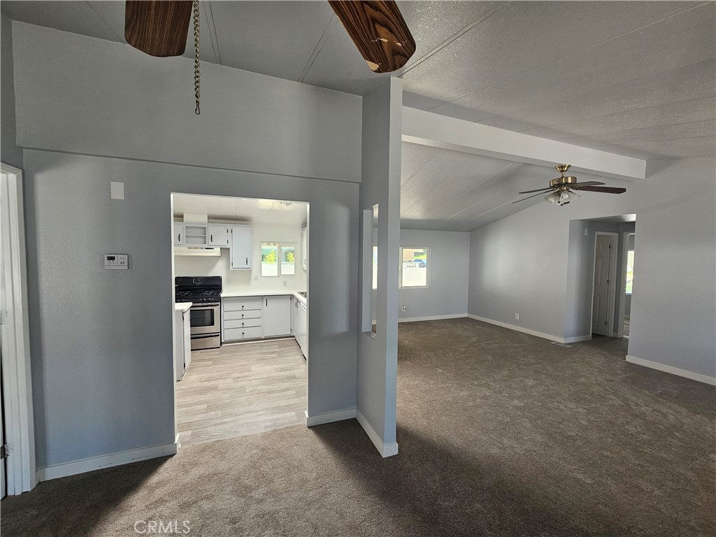 1721 East Colton Avenue, Unit 33 Redlands, CA 92374 - Photo 8 of 17 a view of a hallway with wooden shelves