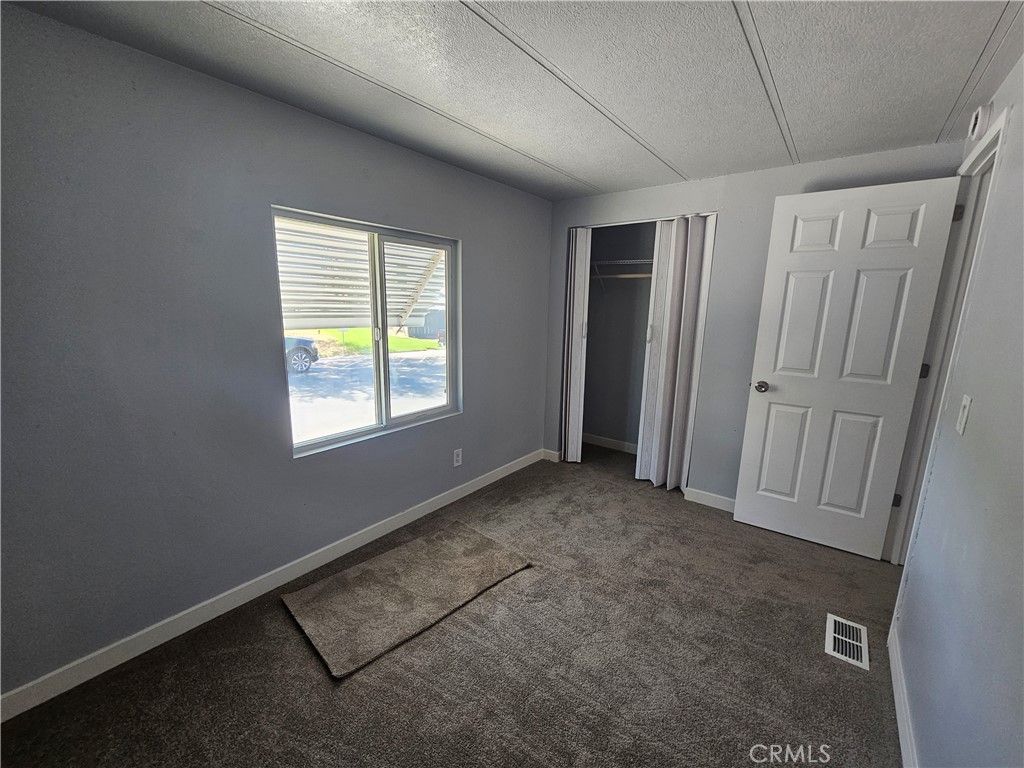 1721 East Colton Avenue, Unit 33 Redlands, CA 92374 - Photo 9 of 17 an empty room with windows
