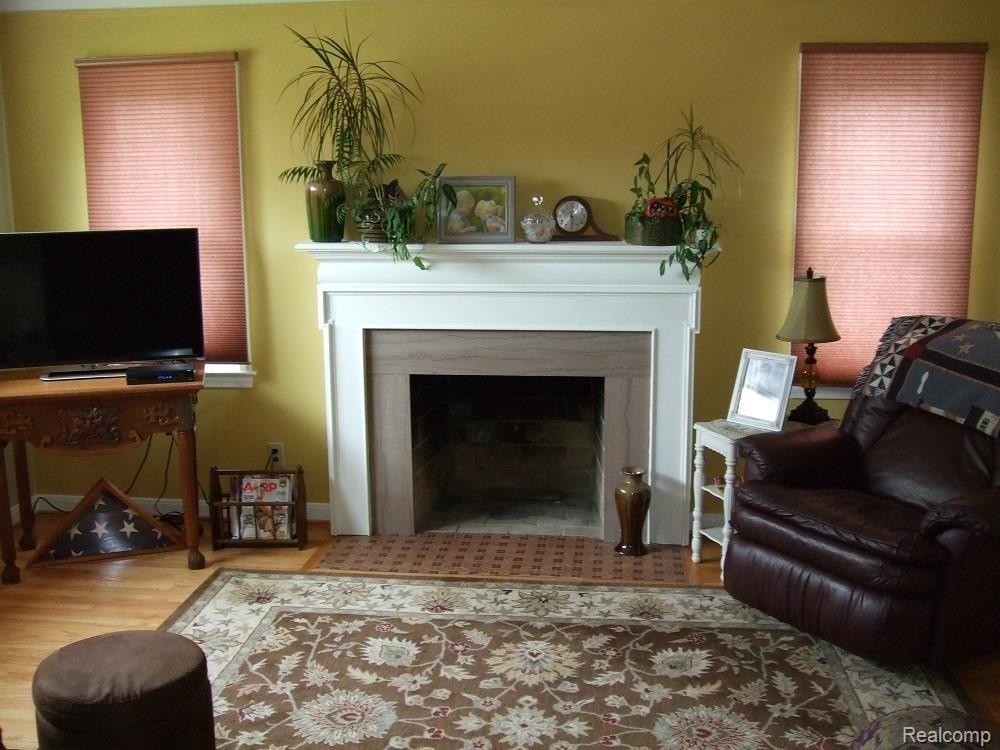 9406 Ruth Avenue Allen Park, MI 48101 - Photo 10 of 31 LIVING ROOM WITH HARDWOOD FLOORING AND NATURAL FIREPLACE.