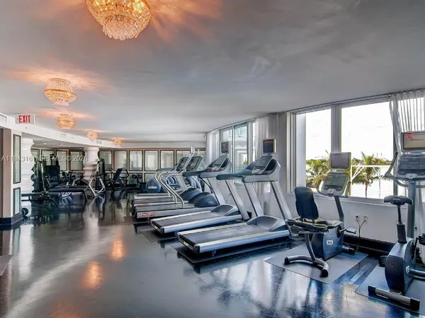 a living room with lots of furniture and a floor to ceiling window