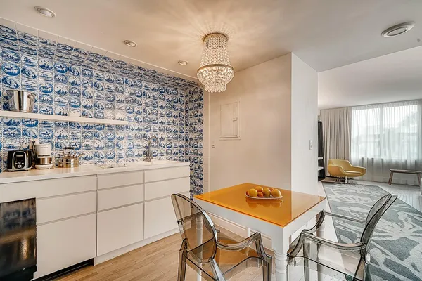 a room with a table chairs and a stove