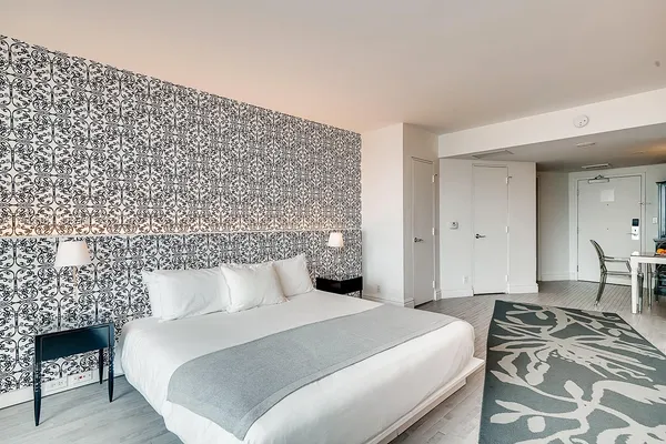 a bedroom with a bed and a lamp