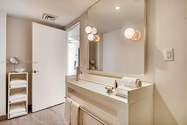 a bathroom with a sink and a mirror