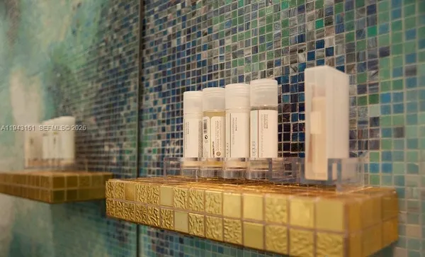 a bathroom with a granite countertop sink and a large mirror