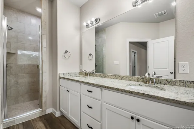 a bathroom with a granite countertop sink mirror and double