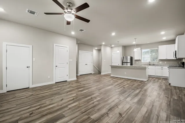 a view of kitchen with wooden floor and a window