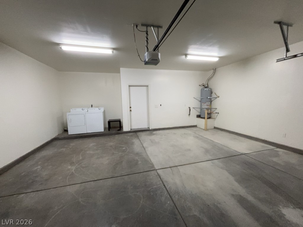 4915 East Russell Road, Unit 159 Las Vegas, NV 89120 - Photo 5 of 12 Garage with washing machine and dryer, strapped water heater, and a garage door opener