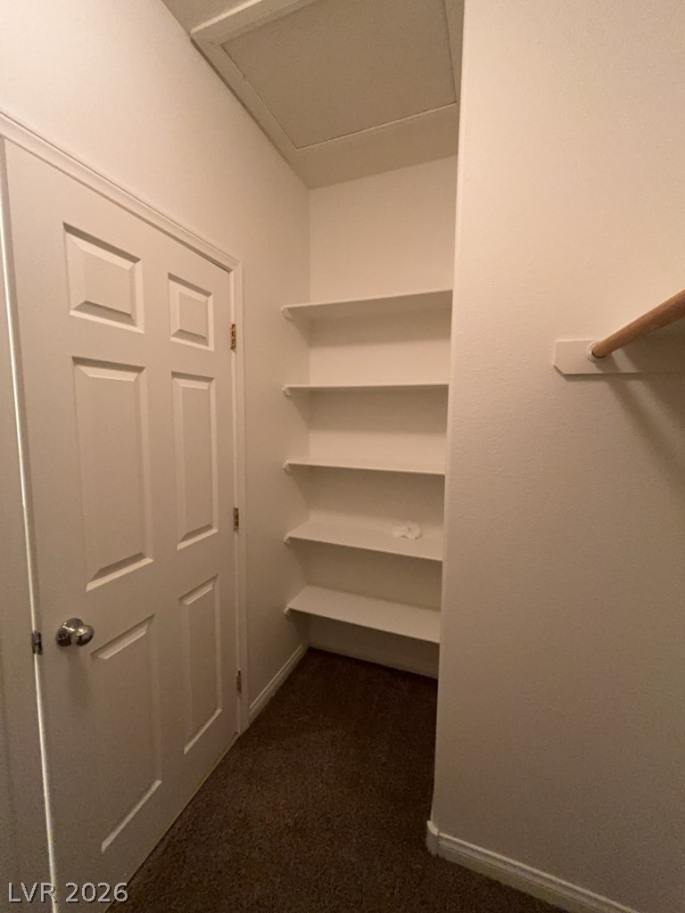 4915 East Russell Road, Unit 159 Las Vegas, NV 89120 - Photo 10 of 12 Walk in closet with attic access and dark colored carpet