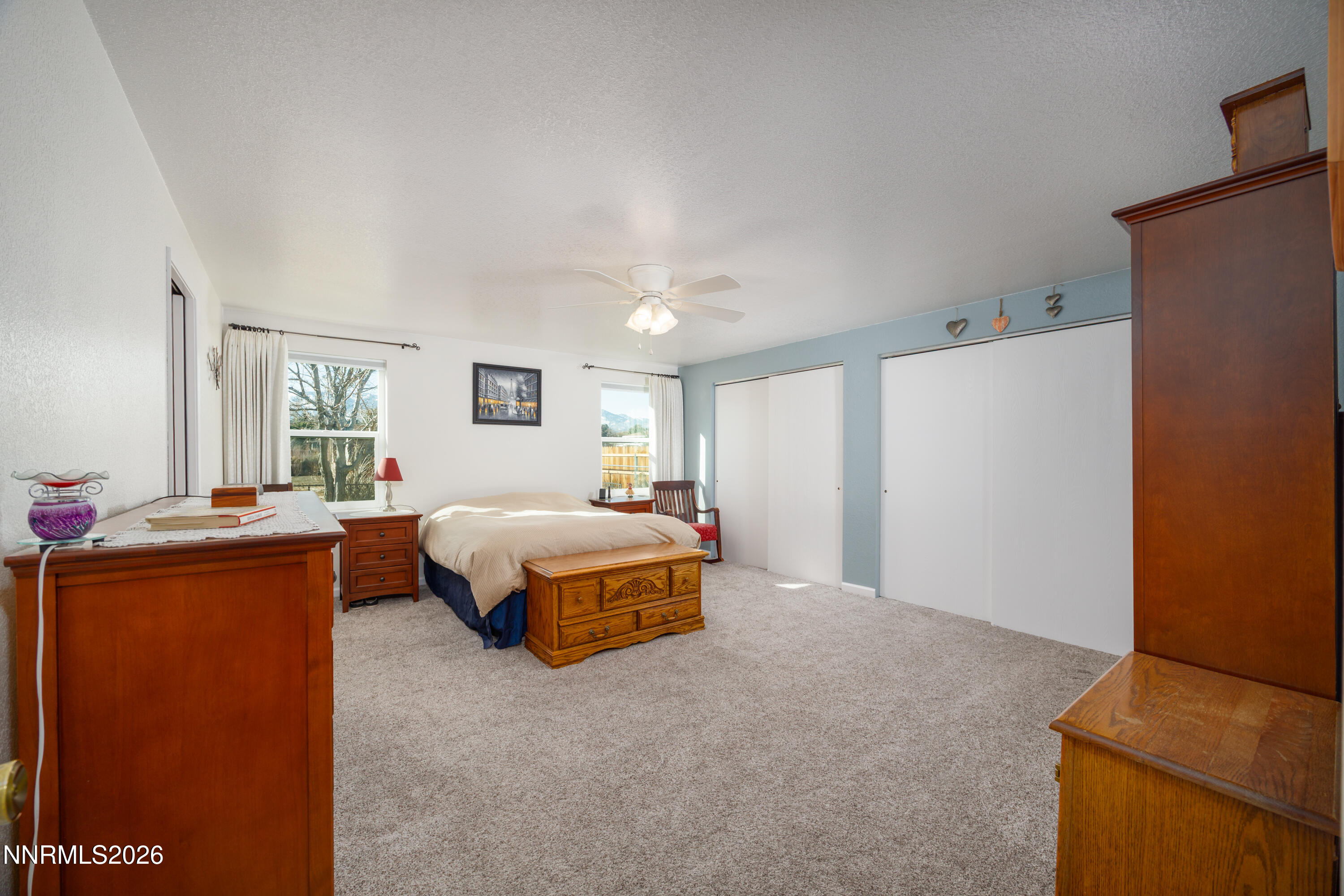 450 Riparian Way Carson City, NV 89701 - Photo 11 of 27 a spacious bedroom with a bed and a dresser in it