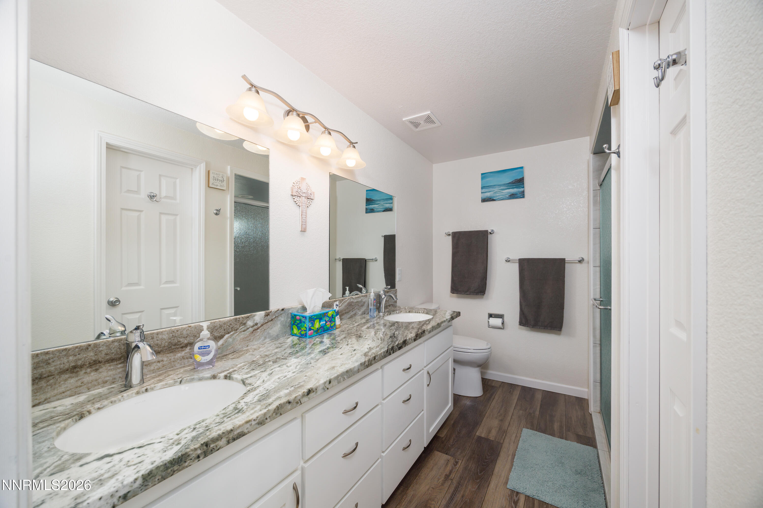 450 Riparian Way Carson City, NV 89701 - Photo 12 of 27 a bathroom with a granite countertop double vanity sink and mirror