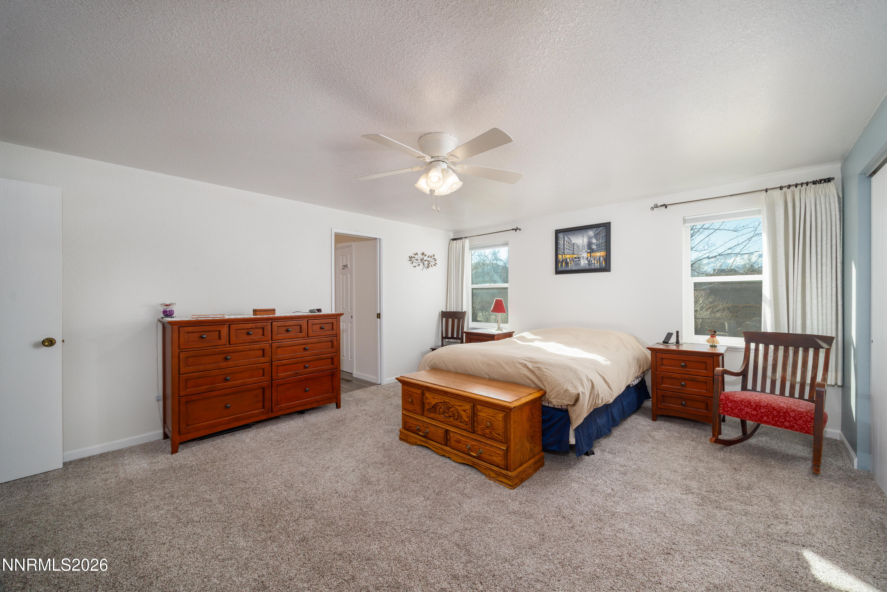 450 Riparian Way Carson City, NV 89701 - Photo 10 of 27 a spacious bedroom with a bed and a chandelier