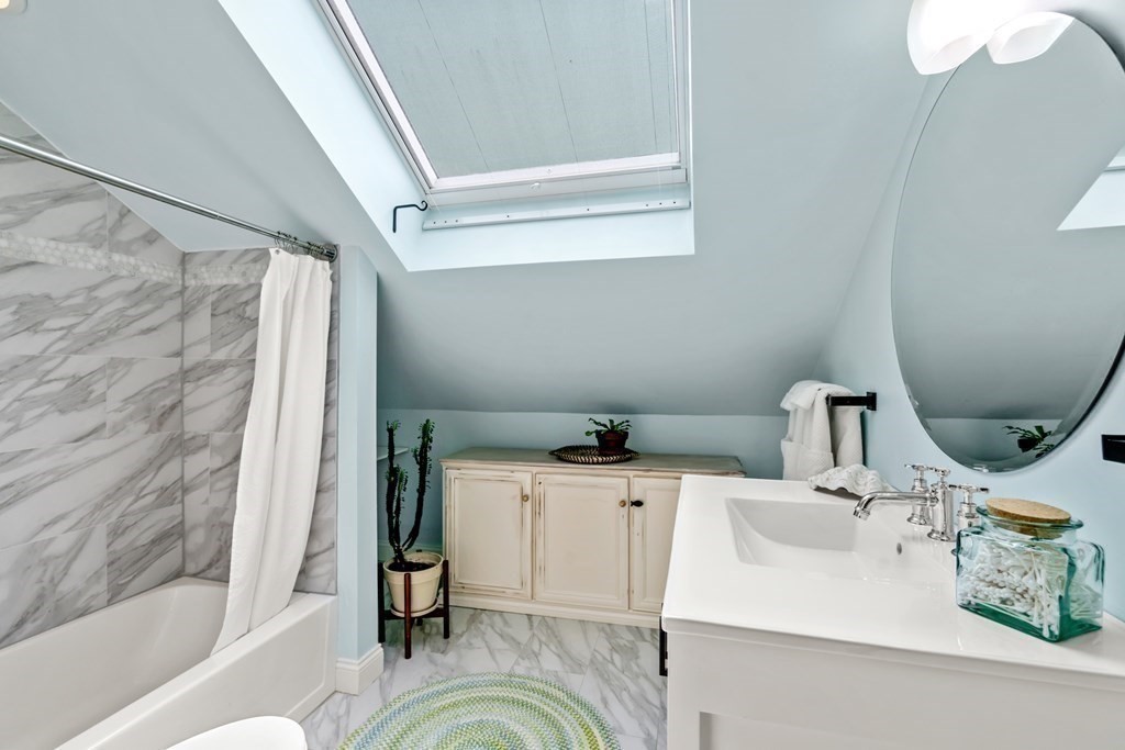 1-3 Howard Place, Unit B Boston, MA 02125 - Photo 14 of 25 a bathroom with a sink and a mirror