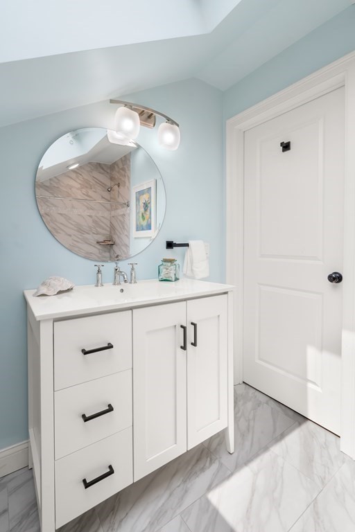1-3 Howard Place, Unit B Boston, MA 02125 - Photo 16 of 25 a bathroom with a sink vanity and a mirror