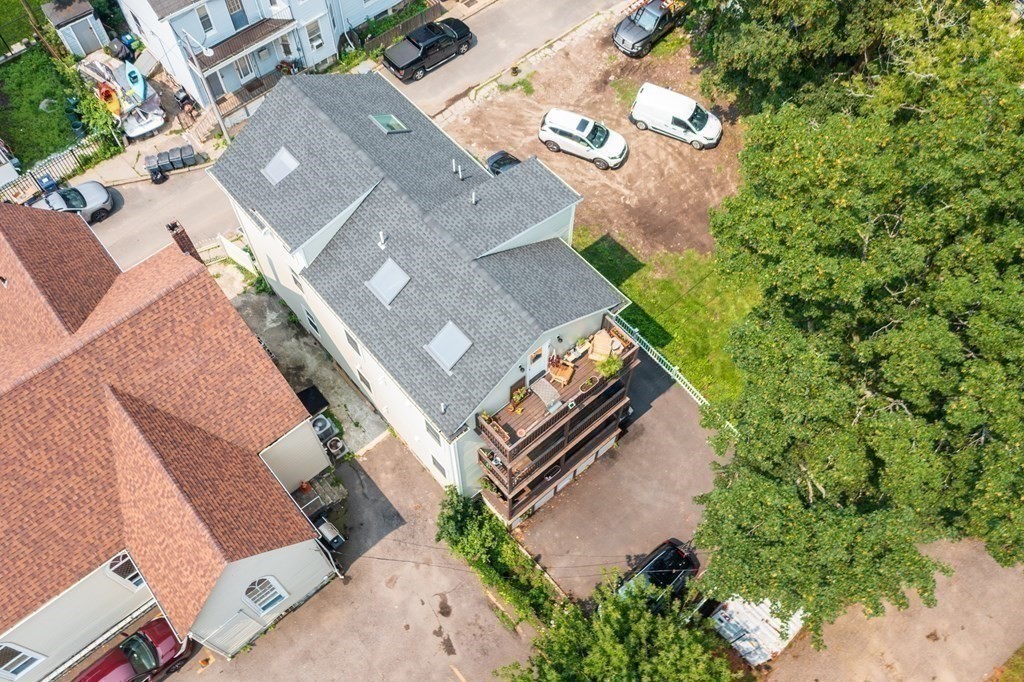 1-3 Howard Place, Unit B Boston, MA 02125 - Photo 18 of 25 an aerial view of a house with a yard and garden