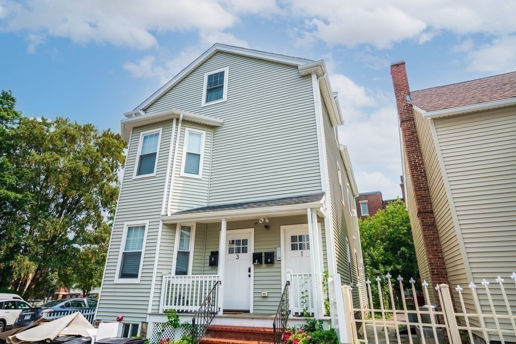 1-3 Howard Place, Unit B Boston, MA 02125 - Photo 24 of 25 a front view of a house with a yard
