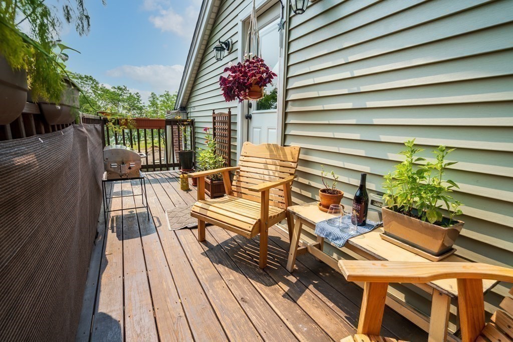 1-3 Howard Place, Unit B Boston, MA 02125 - Photo 8 of 25 a view of a balcony with wooden floor and outdoor seating
