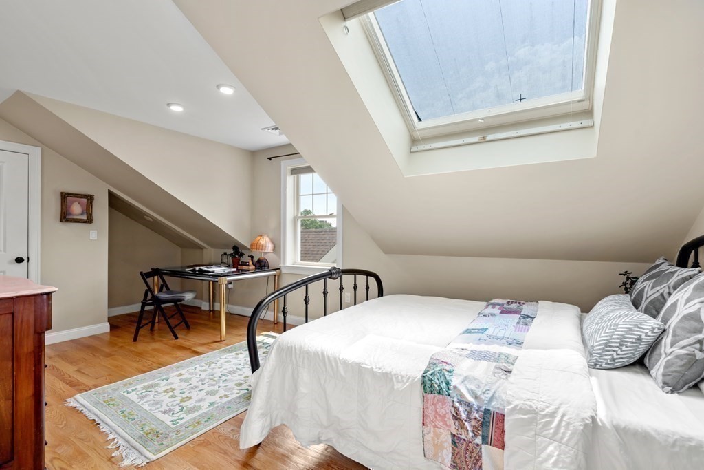 1-3 Howard Place, Unit B Boston, MA 02125 - Photo 9 of 25 a bedroom with a bed a table and chair