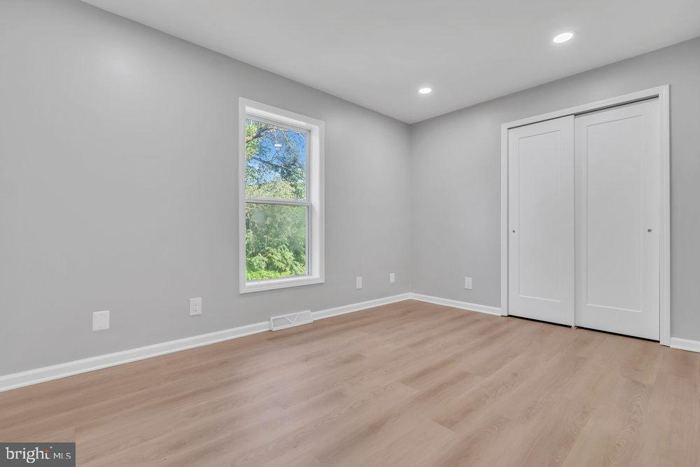 345 Spruce Street Bridgeton, NJ 08302 - Photo 13 of 43 a view of an empty room with wooden floor and a window