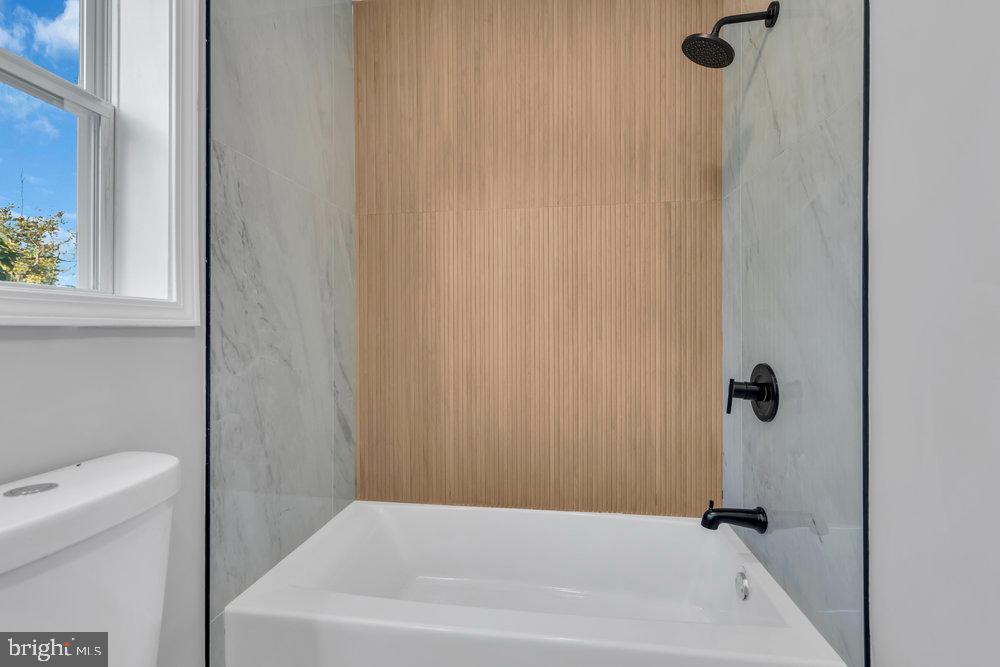 345 Spruce Street Bridgeton, NJ 08302 - Photo 15 of 43 a bathroom with a white bath tub