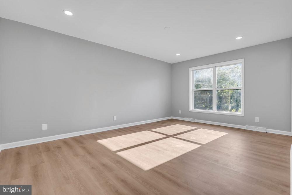 345 Spruce Street Bridgeton, NJ 08302 - Photo 17 of 43 an empty room with wooden floor and windows