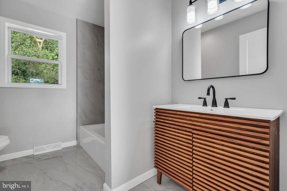 345 Spruce Street Bridgeton, NJ 08302 - Photo 20 of 43 a bathroom with a sink and a mirror