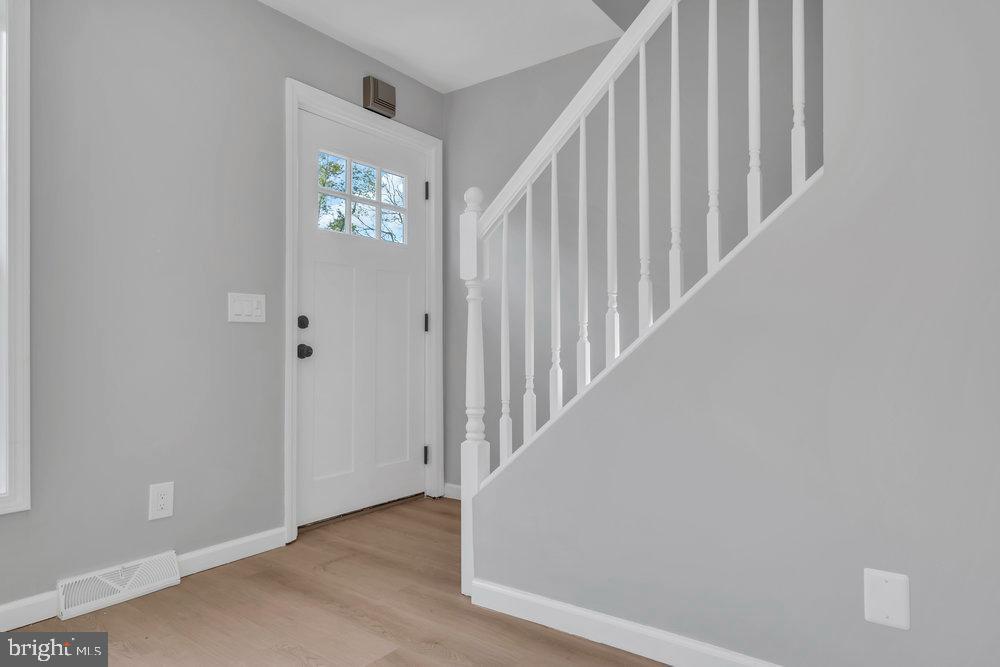 345 Spruce Street Bridgeton, NJ 08302 - Photo 22 of 43 a view of staircase with wooden floor and white walls