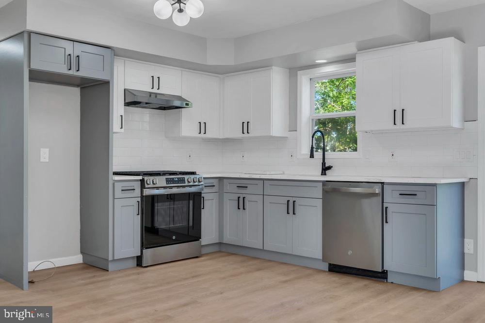 345 Spruce Street Bridgeton, NJ 08302 - Photo 25 of 43 a kitchen with stainless steel appliances a sink stove and cabinets