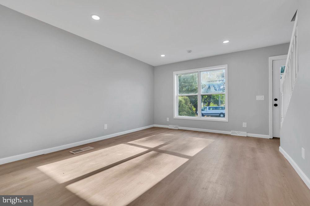 345 Spruce Street Bridgeton, NJ 08302 - Photo 26 of 43 an empty room with wooden floor and windows
