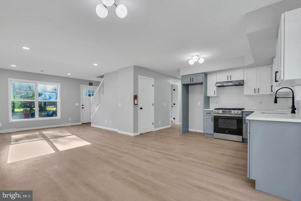 345 Spruce Street Bridgeton, NJ 08302 - Photo 28 of 43 a view of a kitchen with a sink a stove and a window