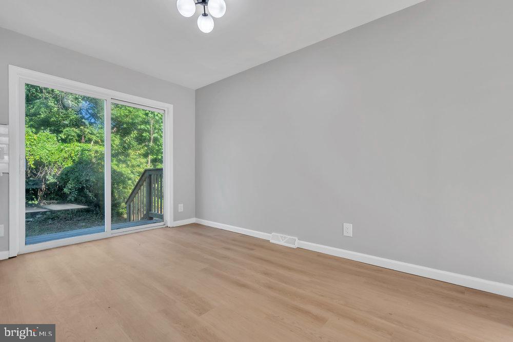 345 Spruce Street Bridgeton, NJ 08302 - Photo 29 of 43 wooden floor in an empty room with a window