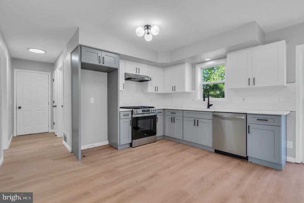 345 Spruce Street Bridgeton, NJ 08302 - Photo 30 of 43 a kitchen with white cabinets and white appliances