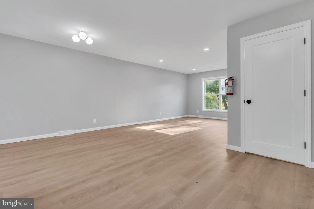 345 Spruce Street Bridgeton, NJ 08302 - Photo 33 of 43 an empty room with wooden floor and windows