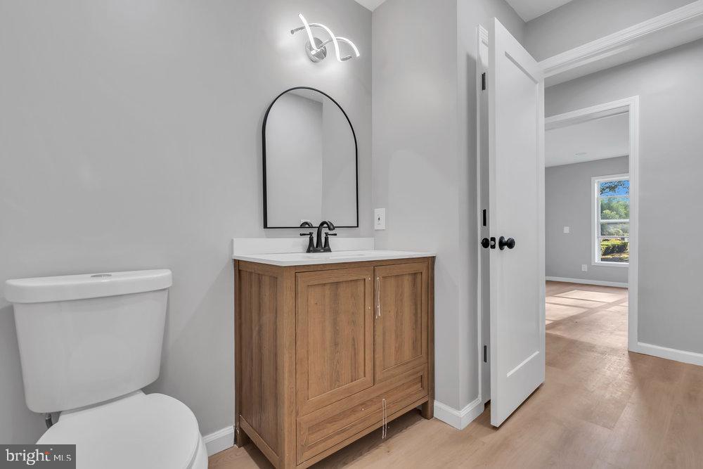 345 Spruce Street Bridgeton, NJ 08302 - Photo 35 of 43 a bathroom with a toilet a sink and mirror