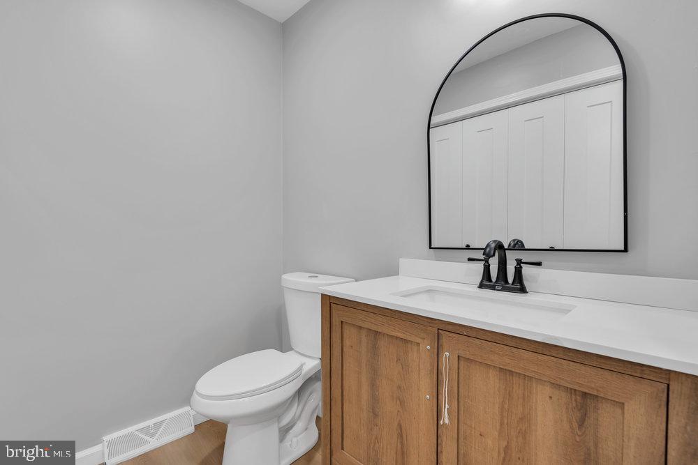 345 Spruce Street Bridgeton, NJ 08302 - Photo 36 of 43 a bathroom with a sink toilet and mirror