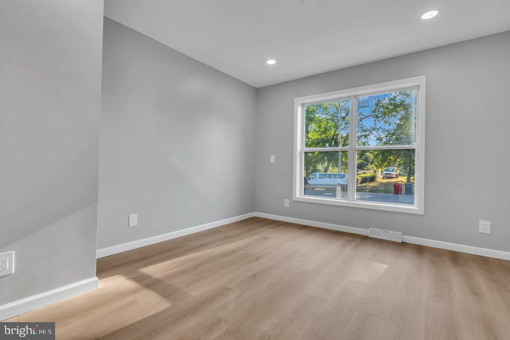 345 Spruce Street Bridgeton, NJ 08302 - Photo 37 of 43 an empty room with wooden floor and windows