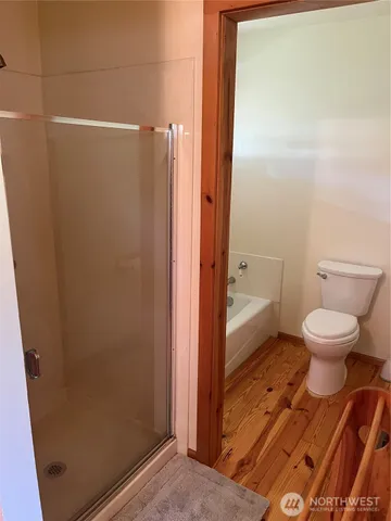 a bathroom with a toilet and a shower