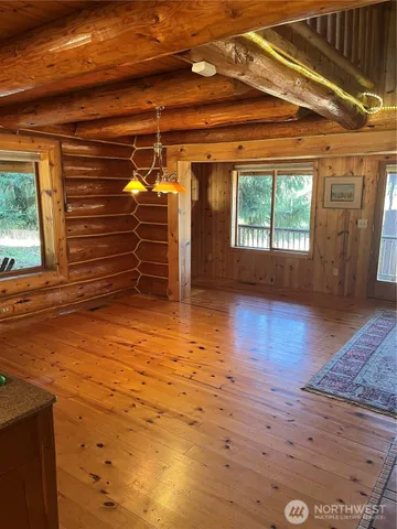 a view of a room with wooden floor and windows