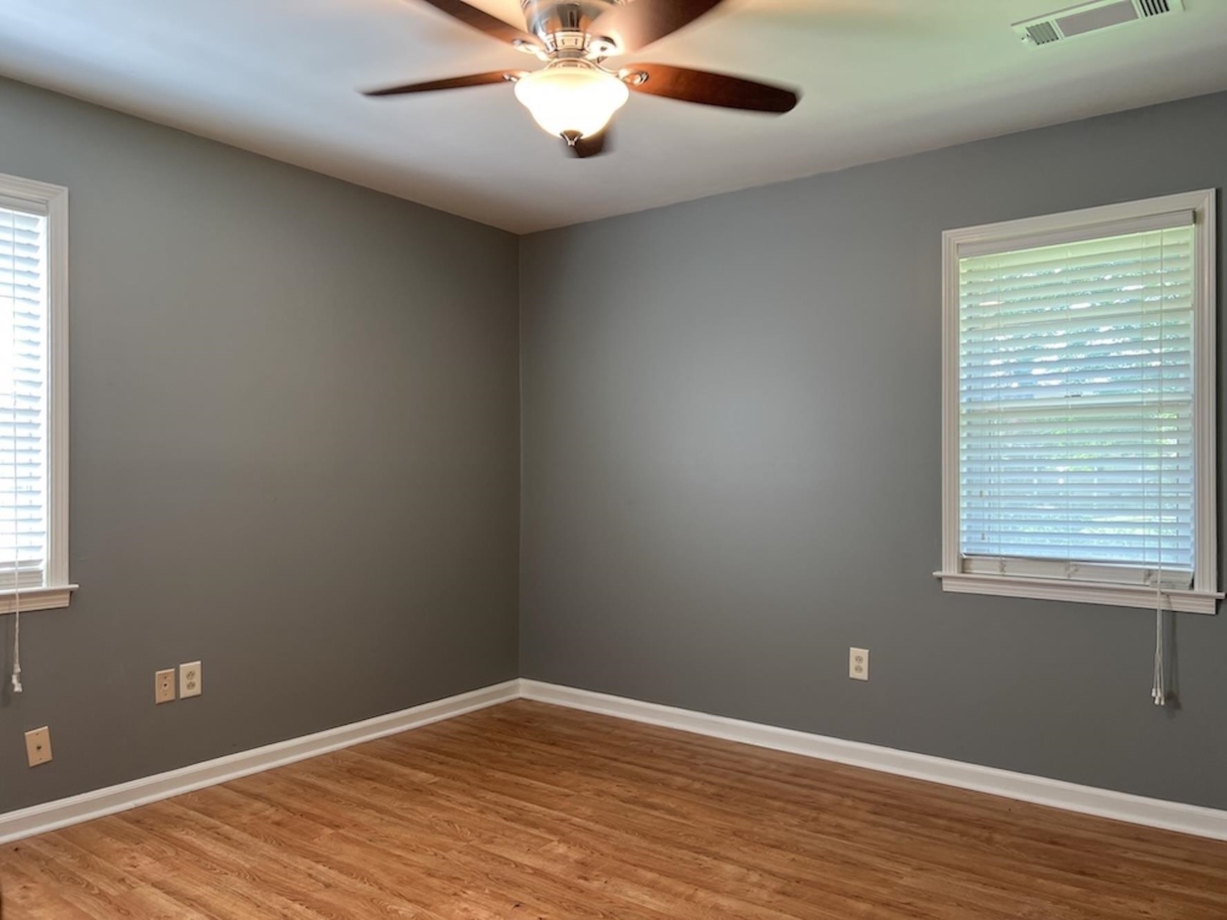 7935 Memphis Arlington Road Bartlett, TN 38133 - Photo 13 of 20 Gray-painted interior featuring wood-finish flooring, white baseboards, and a ceiling fan with integrated lighting