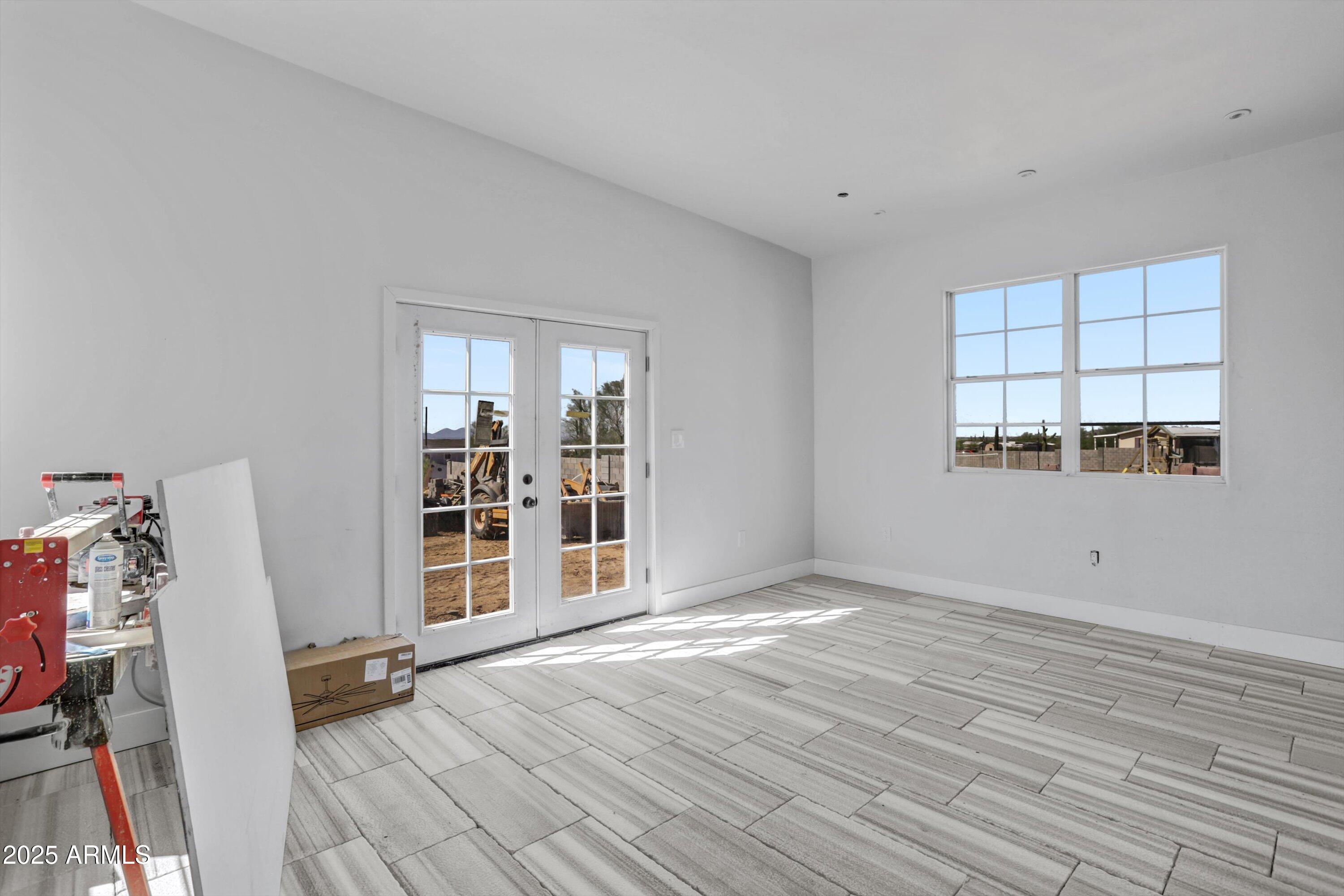 317 West Frontier Street Apache Junction, AZ 85120 - Photo 11 of 28 a view of an empty room with wooden floor and a window