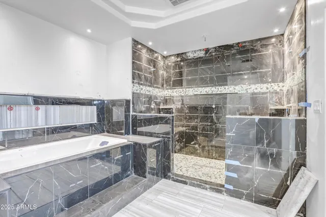 a spacious bathroom with a tub and shower