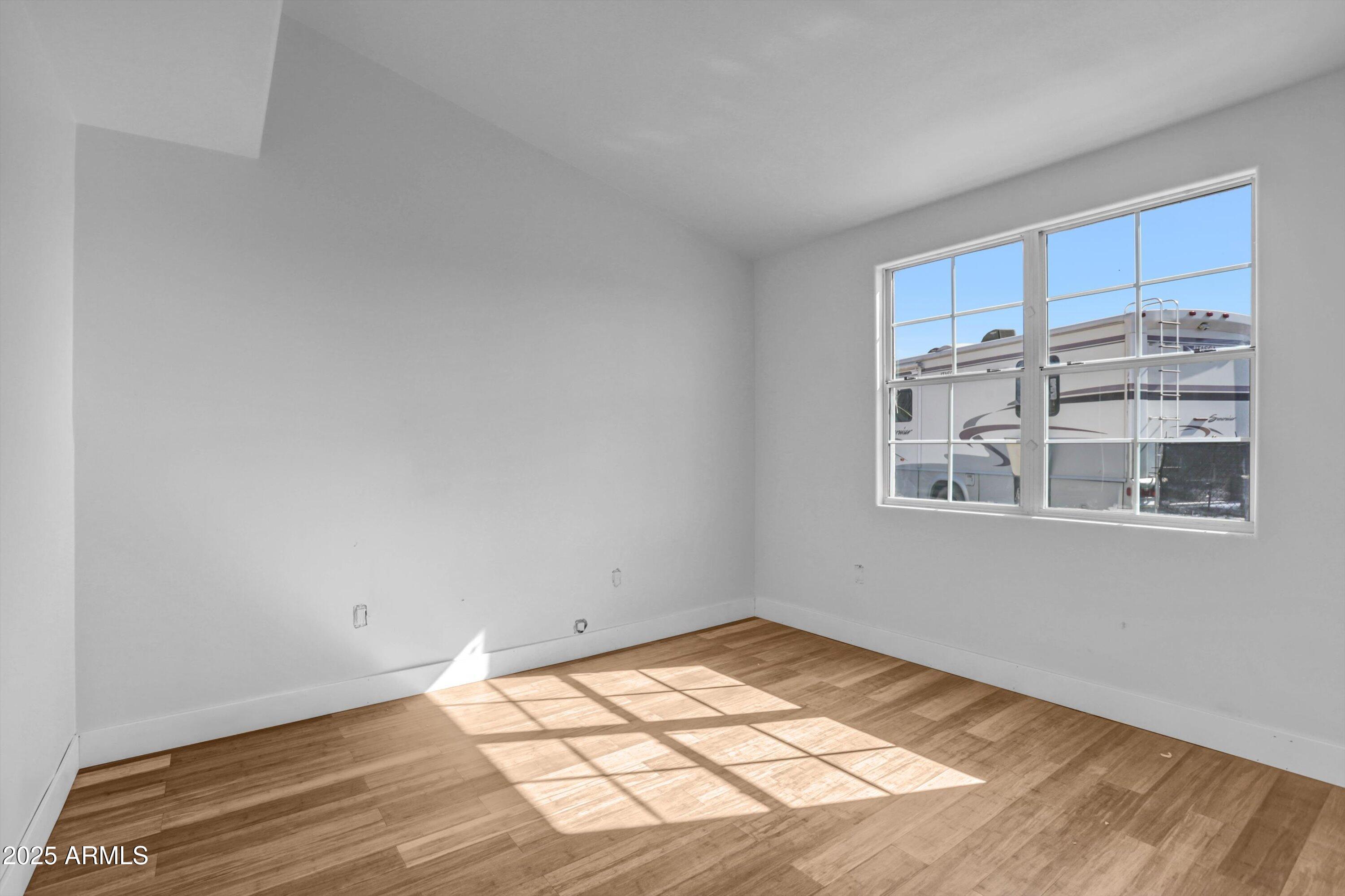 317 West Frontier Street Apache Junction, AZ 85120 - Photo 15 of 28 a view of empty room with wooden floor and fan