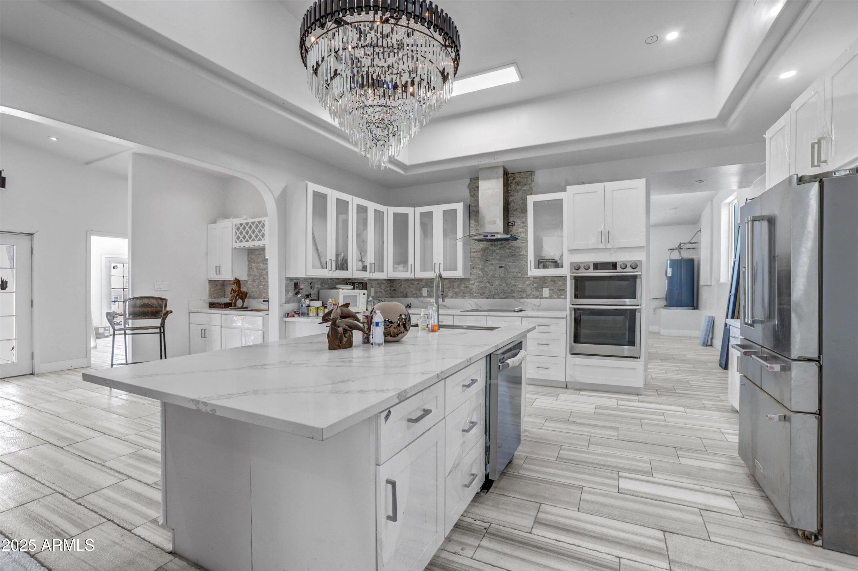 317 West Frontier Street Apache Junction, AZ 85120 - Photo 21 of 28 a kitchen with stainless steel appliances a table chairs in it and an empty room